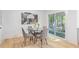 Cozy eat-in kitchen featuring modern table, a glass table top and gray upholstered chairs at 330 Spring Lake Ter, Roswell, GA 30076