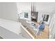 Open-concept living room with modern lighting, a fireplace, and natural light at 330 Spring Lake Ter, Roswell, GA 30076