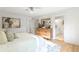 Sun-filled main bedroom features hardwood floors, modern decor, and a door to the ensuite bathroom at 330 Spring Lake Ter, Roswell, GA 30076