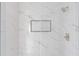 Modern shower with white marble-patterned tile and inset at 330 Spring Lake Ter, Roswell, GA 30076