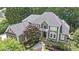 Stunning aerial view of a grand home, highlighting its lush landscaping and impressive architectural details at 3915 Merriweather Woods, Johns Creek, GA 30022