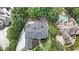 Overhead view of home with stone-lined gardens, manicured yard, and neighborhood pool at 3915 Merriweather Woods, Johns Creek, GA 30022