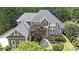 Beautiful aerial view of a grand home, surrounded by lush landscaping and mature trees, offering privacy and curb appeal at 3915 Merriweather Woods, Johns Creek, GA 30022