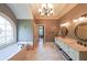 Bright bathroom features a soaking tub beneath an arched window, double vanity with sinks, and elegant lighting at 3915 Merriweather Woods, Johns Creek, GA 30022