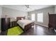 Bedroom featuring hardwood floors, a large bed, and plenty of natural light at 3915 Merriweather Woods, Johns Creek, GA 30022