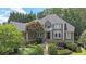 Stately two-story home with mature landscaping, a walkway, and elegant architectural details at 3915 Merriweather Woods, Johns Creek, GA 30022