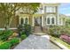 Elegant home with a columned entrance and a well-manicured front yard and walkway at 3915 Merriweather Woods, Johns Creek, GA 30022