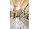 Entryway with marble tile floor, wainscoting, and staircase with decorative chandelier at 3915 Merriweather Woods, Johns Creek, GA 30022