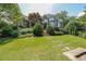 Expansive front yard with lush green lawn and stone walkway leading to the house at 3915 Merriweather Woods, Johns Creek, GA 30022