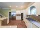Well-equipped kitchen boasts stainless steel appliances, custom cabinetry, granite countertops, and a gas range at 3915 Merriweather Woods, Johns Creek, GA 30022