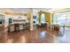 Spacious living room featuring hardwood floors, large windows, fireplace, open kitchen, and neutral color scheme at 3915 Merriweather Woods, Johns Creek, GA 30022
