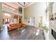Spacious living room with tall windows, fireplace, hardwood floors, and an open floor plan at 3915 Merriweather Woods, Johns Creek, GA 30022