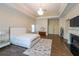 Bright main bedroom boasts hardwood floors, fireplace, tray ceiling, and elegant chandelier at 3915 Merriweather Woods, Johns Creek, GA 30022