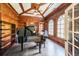 Wood-paneled office with a beamed ceiling, a grand piano, and built-in shelving at 3915 Merriweather Woods, Johns Creek, GA 30022