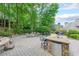 Inviting outdoor kitchen area featuring stone countertops, a mini fridge, and comfortable seating for entertaining guests at 3915 Merriweather Woods, Johns Creek, GA 30022