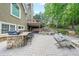 Paver patio with outdoor bar, spa, waterfall, and stairs up to the deck create luxurious outdoor living at 3915 Merriweather Woods, Johns Creek, GA 30022