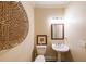 Stylish powder room features a pedestal sink, framed mirror, and decorative accents at 3915 Merriweather Woods, Johns Creek, GA 30022