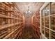 Wine cellar with extensive shelving, brick ceiling, and decorative stone flooring at 3915 Merriweather Woods, Johns Creek, GA 30022