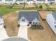 Aerial view of a charming gray home with a large driveway and landscaped front yard at 4470 Madison Hall Dr, Cumming, GA 30028
