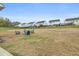 Large fenced backyard with a fire pit and Adirondack chairs at 4470 Madison Hall Dr, Cumming, GA 30028