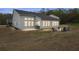 Wide backyard view featuring a fire pit, Adirondack chairs, and a grill on the patio at 4470 Madison Hall Dr, Cumming, GA 30028
