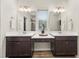 Bathroom boasts a double vanity with undermount sinks and dark wood cabinets at 4470 Madison Hall Dr, Cumming, GA 30028