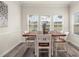 Inviting dining room with a wooden table, seating for six, and natural light from multiple windows at 4470 Madison Hall Dr, Cumming, GA 30028