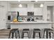 Bright, modern kitchen with stainless steel appliances, granite countertops, and a breakfast bar at 4470 Madison Hall Dr, Cumming, GA 30028