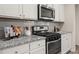 Stylish kitchen with granite countertops, stainless steel appliances, and ample cabinet space at 4470 Madison Hall Dr, Cumming, GA 30028