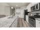 Modern kitchen with stainless steel appliances, granite countertops, and a large island at 4470 Madison Hall Dr, Cumming, GA 30028