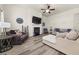 Spacious living room with hardwood floors, a cozy fireplace, and comfortable seating arrangements at 4470 Madison Hall Dr, Cumming, GA 30028