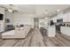 Open-concept living space with hardwood floors, a modern kitchen, and a comfortable seating area at 4470 Madison Hall Dr, Cumming, GA 30028