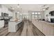 Open-concept living space featuring a kitchen island, dining area, and comfortable sofa at 4470 Madison Hall Dr, Cumming, GA 30028