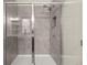 Modern tiled shower with glass door and chrome fixtures at 4470 Madison Hall Dr, Cumming, GA 30028