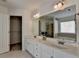 Bathroom featuring double sinks, a tub, and a walk-in closet at 580 Hammersmith Dr, Suwanee, GA 30024