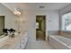Bathroom features double sinks and a separate tub and shower at 580 Hammersmith Dr, Suwanee, GA 30024