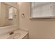 Bathroom features a single sink with vanity, mirror, and window with natural light at 580 Hammersmith Dr, Suwanee, GA 30024