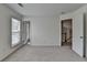 Carpeted room with two windows, neutral paint and an open door to the next room at 580 Hammersmith Dr, Suwanee, GA 30024
