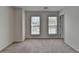 Bright bedroom featuring neutral carpet, white walls, and natural light from two windows at 580 Hammersmith Dr, Suwanee, GA 30024