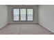 Bedroom with neutral carpet, baseboards, and trim, along with natural light from the windows at 580 Hammersmith Dr, Suwanee, GA 30024