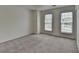 Light-filled bedroom with plush carpeting and ample natural light at 580 Hammersmith Dr, Suwanee, GA 30024