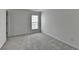 Neutral carpeted room with a single window, white walls and a white door at 580 Hammersmith Dr, Suwanee, GA 30024
