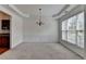 Elegant dining room with chair rail, tray ceiling, and chandelier. View into adjacent room at 580 Hammersmith Dr, Suwanee, GA 30024