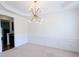 Bright dining room with modern chandelier and chair rail at 580 Hammersmith Dr, Suwanee, GA 30024