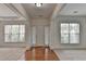 Bright foyer with hardwood floors, fresh paint, and a view of the surrounding rooms through large windows at 580 Hammersmith Dr, Suwanee, GA 30024