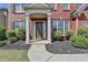 Inviting front entrance with a covered porch, lush landscaping, and a brick facade at 580 Hammersmith Dr, Suwanee, GA 30024