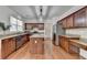 Spacious kitchen features granite countertops, stainless steel appliances, a central island and wood floors at 580 Hammersmith Dr, Suwanee, GA 30024