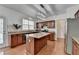 Kitchen with granite countertops, an island and wood cabinets at 580 Hammersmith Dr, Suwanee, GA 30024
