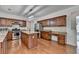 Charming kitchen features stainless steel appliances, granite countertops and a central island with breakfast bar at 580 Hammersmith Dr, Suwanee, GA 30024