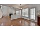 Open living space features a fireplace, large windows, hardwood floors and access to the back patio at 580 Hammersmith Dr, Suwanee, GA 30024